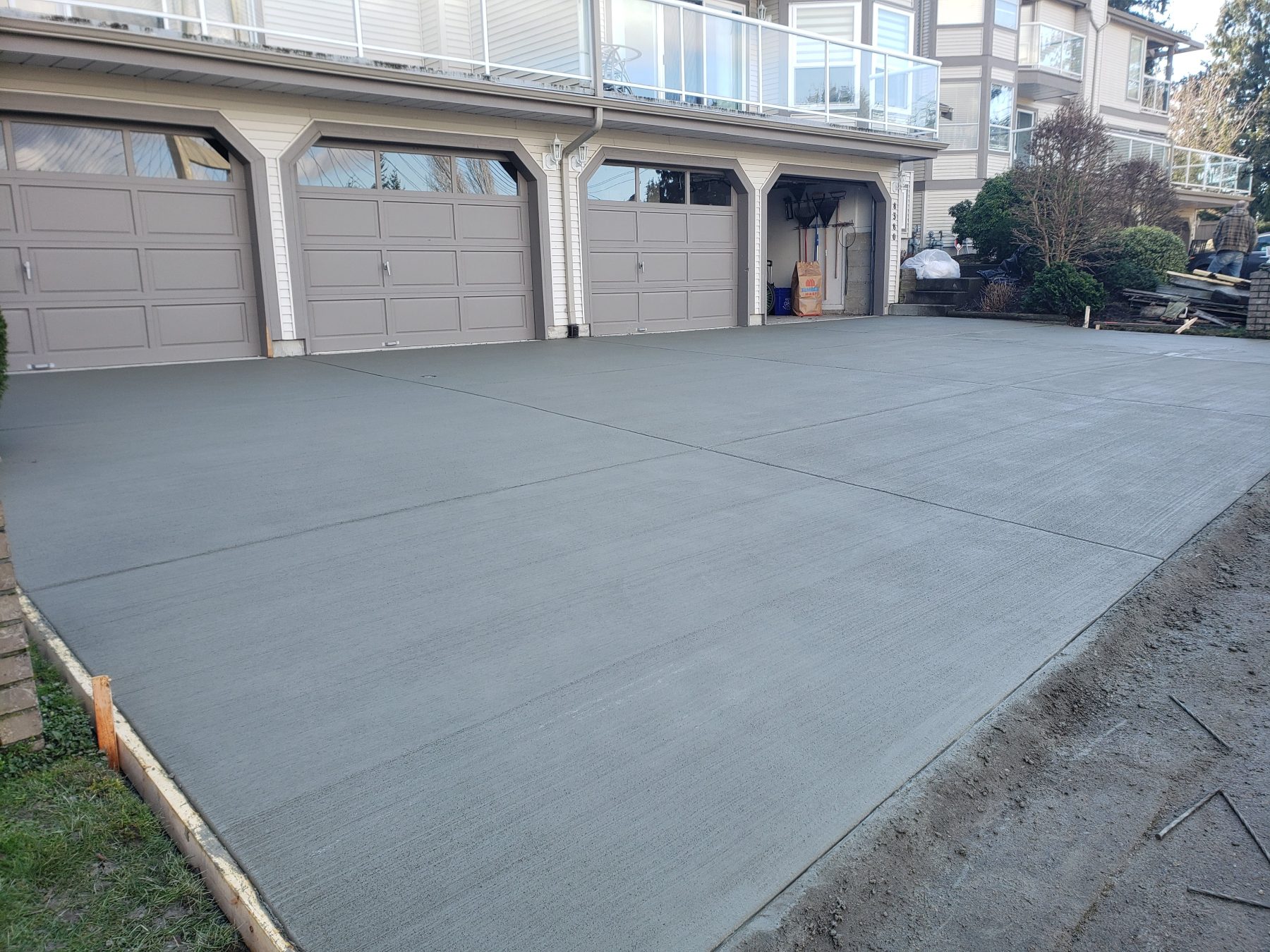 Fresh broom finish concrete driveway in front of a Lower Mainland townhouse garage